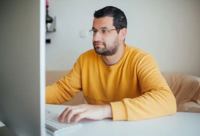 a man sitting in front of a laptop computer