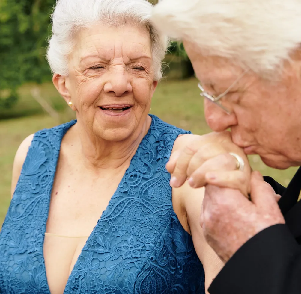 an older man and a younger woman standing next to each other