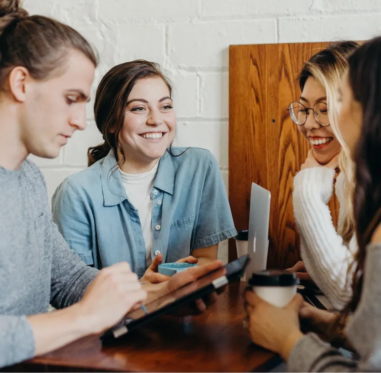 a group of young women sitting around a table