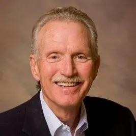 a man in a suit smiling for a picture