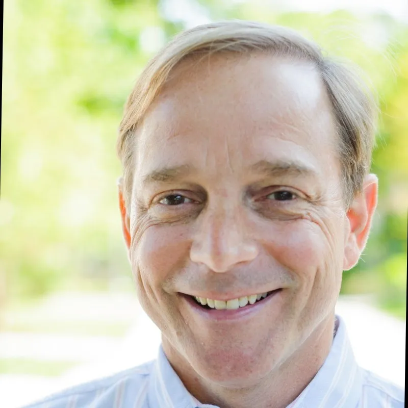 a close up of a person wearing a shirt and tie